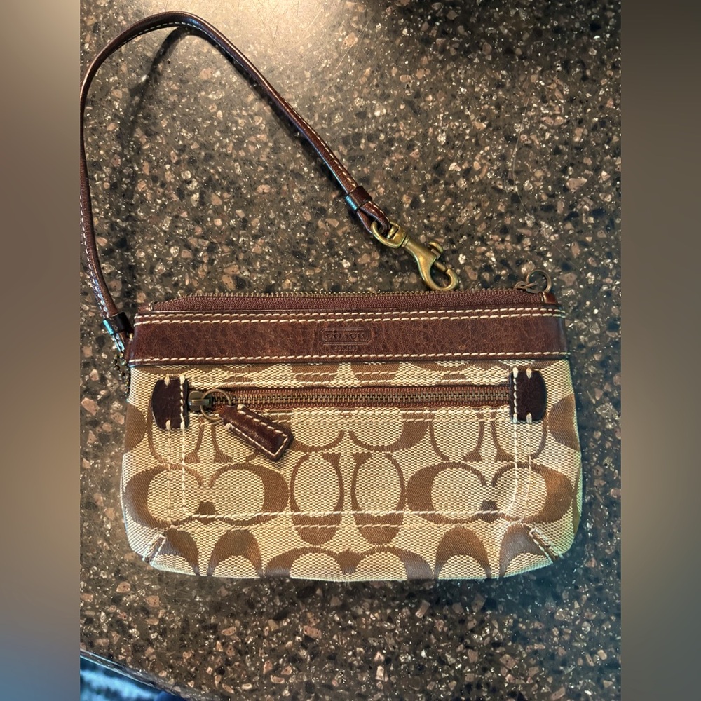 Coach monogram wristlet 7” X 4.5”.